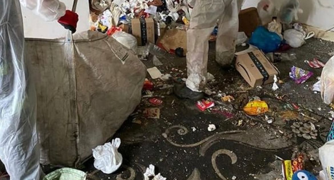 Removers flush waistband into Britain's "worst house" filled with trash and bottles of urine