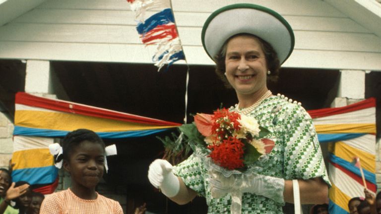 Barbados - November 01: Queen Elizabeth II smiles with a young girl in Barbados on November 1, 1977 in Barbados.  (Photo by Anwar Hussain / Getty Images)