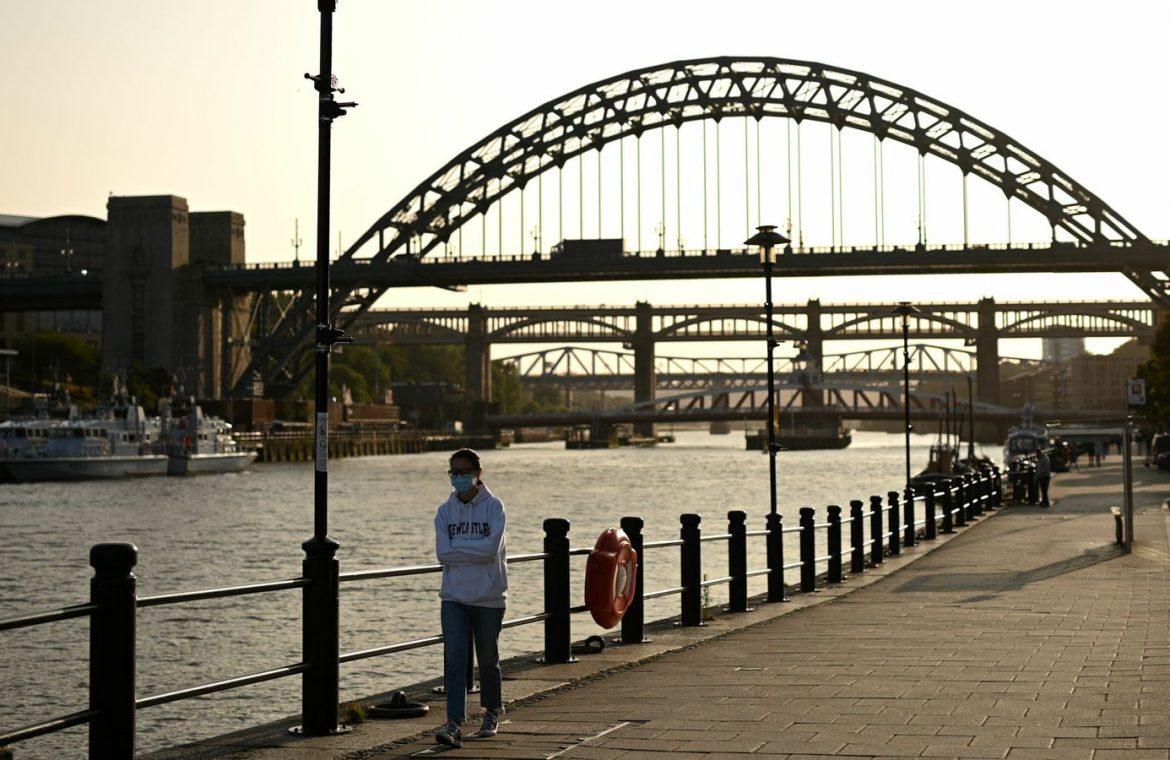 A woman walks near the Tyne Bridge in Newcastle