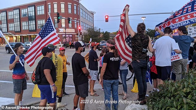 Pictured: Many people waved American flags and tools 