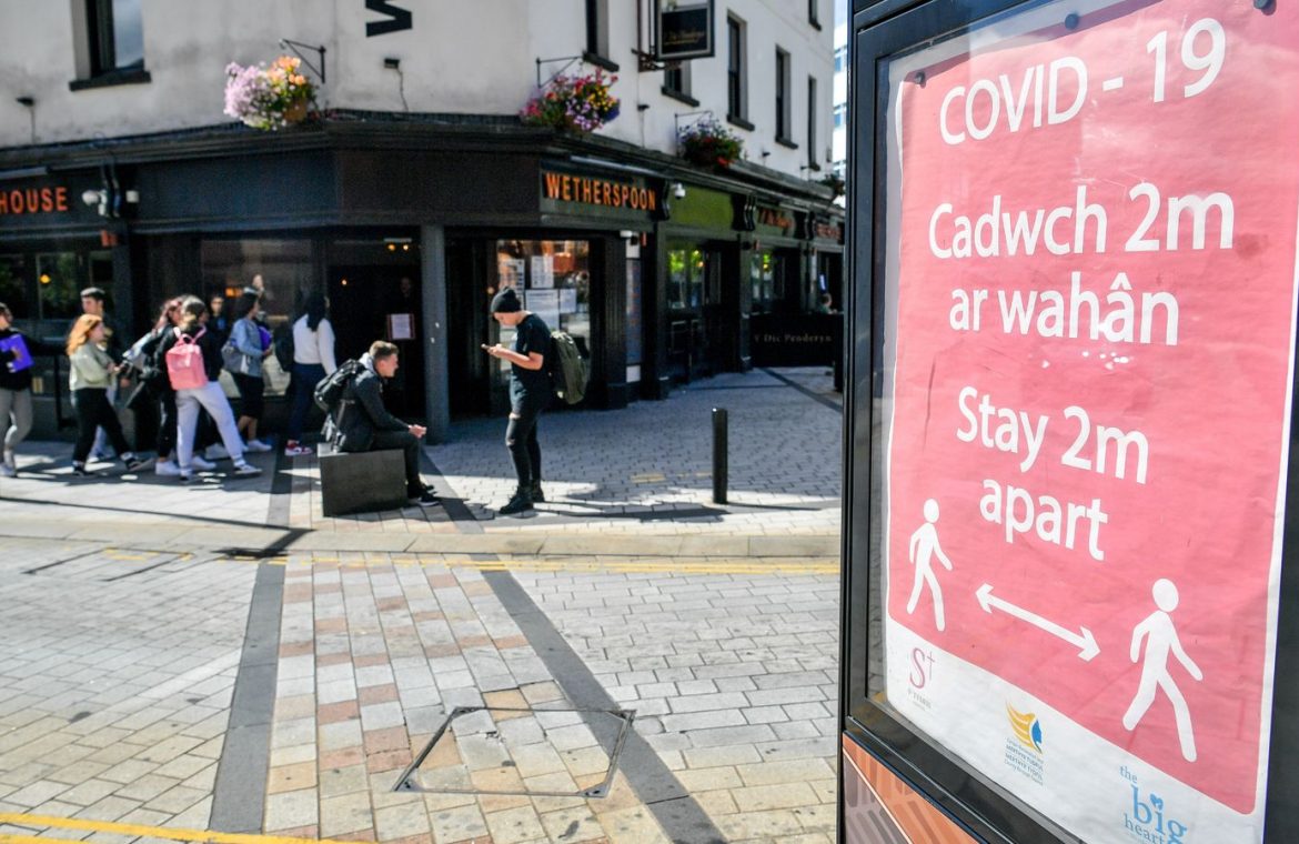 A covid-19 poster opposite a pub in Merthyr Tydfil, Wales
