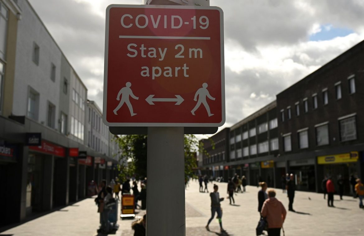 A sign urges people to stay 2m apart in Bolton, the worst-hit place for coronavirus in the country