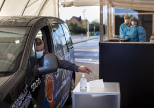 A voter casts his vote at a car polling station, a special place for pre-voting for isolated voters in Vilnius, Lithuania