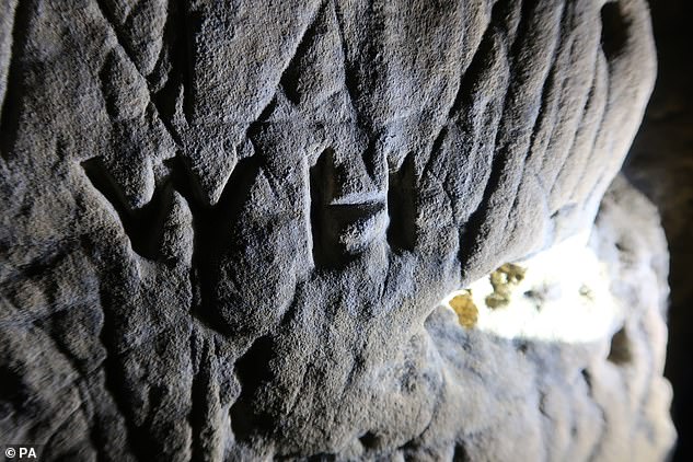 Hundreds of these signs were found adorning the inside of the Creswell Crags limestone caves on the border between Nottinghamshire and Derbyshire last year (pictured)