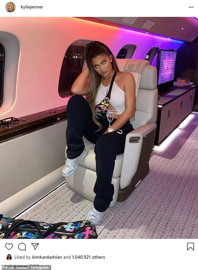 Jet setting: Kylie Jenner, 23, showed off her wide and bendy cleavage at the top of a white lace while she was on a private jet on Saturday