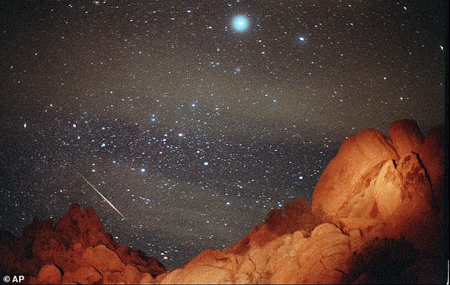 The Leonid meteor shower is set to be shown on an out-of-this-world screen next week, with one meteor appearing across the sky every five minutes during its zenith.  Pictured is the event that appears over Joshua Tree National Park in 1998
