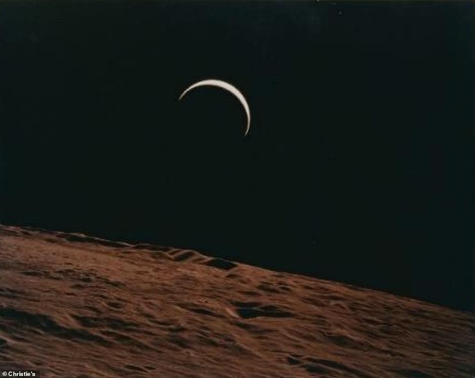 Crescent Earth rising beyond the barren horizon of the Moon, July 26 - August 7, 1971