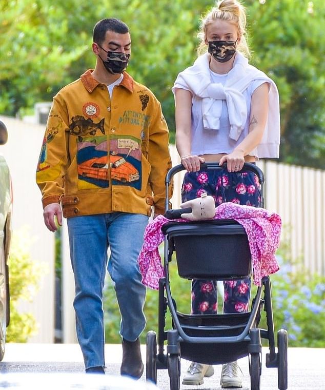 Take it easy: Joe Jonas and Sophie Turner are spotted taking their daughter Willa on a stroll near their Los Angeles home on Friday.