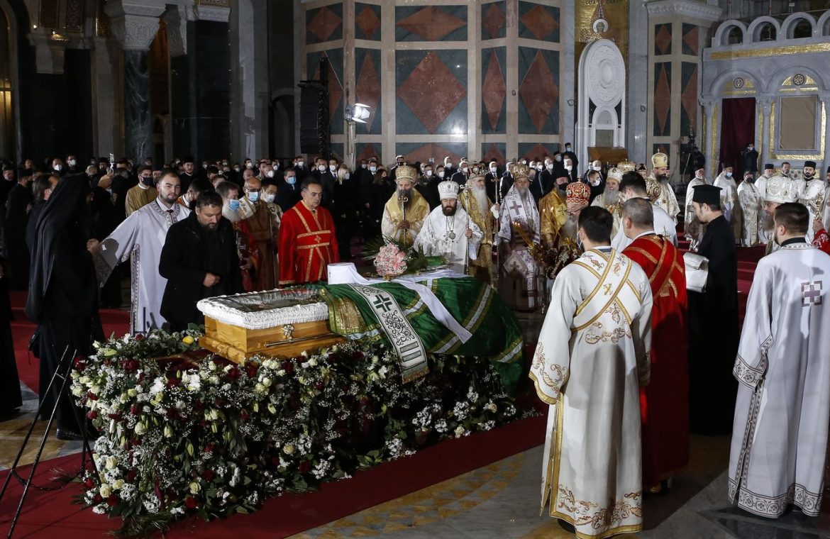Orthodox priests hold the church service during the funeral of the late Serbian Patriarch Irinej