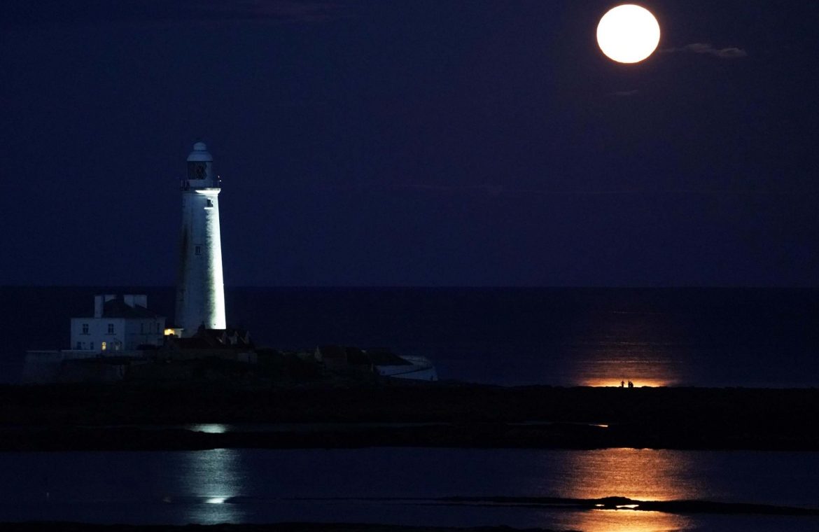 The August Full Moon, known as the  Sturgeon Moon, rises above St Mary's Lighthouse in Whitley Bay