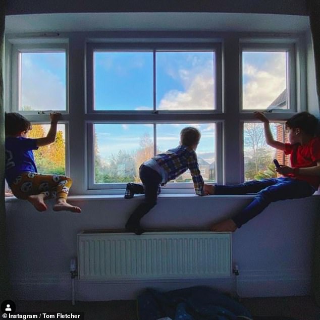 Sexy: The McFly star later posted a snapshot of their three sons - Buzz, Buddy, and Max - patiently waiting for Giovanna to get home