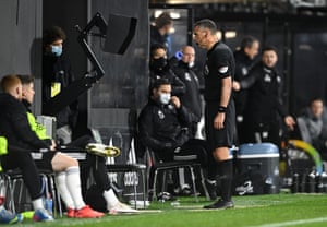 Referee Andre Marriner reviews the pitch display for a VAR examination and decides otherwise