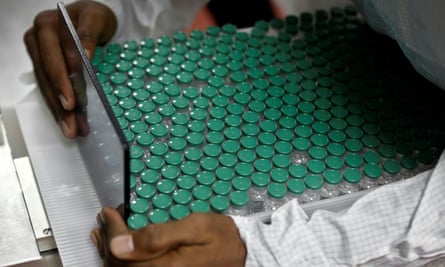 A doctor carries vials of Covid vaccine to AstraZeneca in Pune, India.