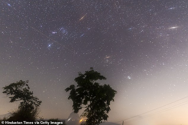 More than 100 multicolored stars are scheduled to spread across the night sky this weekend during the peak of the Geminid meteor showers.  Pictured is the Geminid meteor showers seen from Lake Pawna near Lonavala on December 14, 2017 in Mumbai, India.