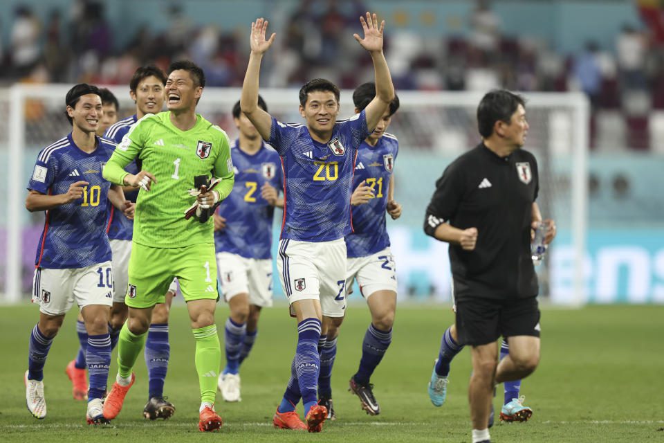 DOHA, QATAR - DECEMBER 1: Japan's Shoto Machino and Eiji Kawashima celebrate beating Spain and qualifying for the knockout stages of the FIFA World Cup during the Group E match of the 2022 Qatar World Cup between Japan and Spain at Khalifa International Stadium on December 1.  2022 in Doha, Qatar.  (Photo by Matthew Ashton - AMA/Getty Images)